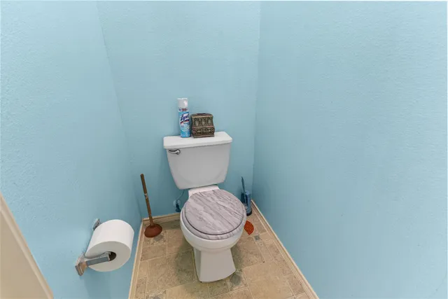 a white toilet sitting in a bathroom