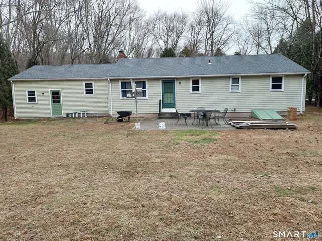a backyard of a house with seating space