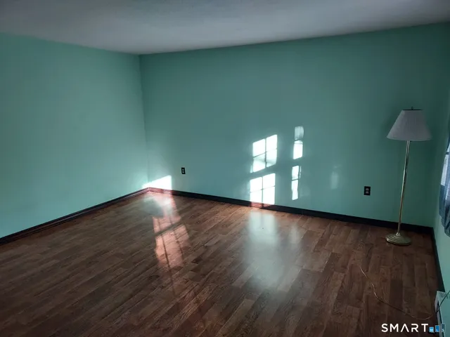 a view of wooden floor and windows in a room