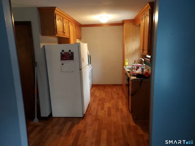 a view of hallway with wooden floor