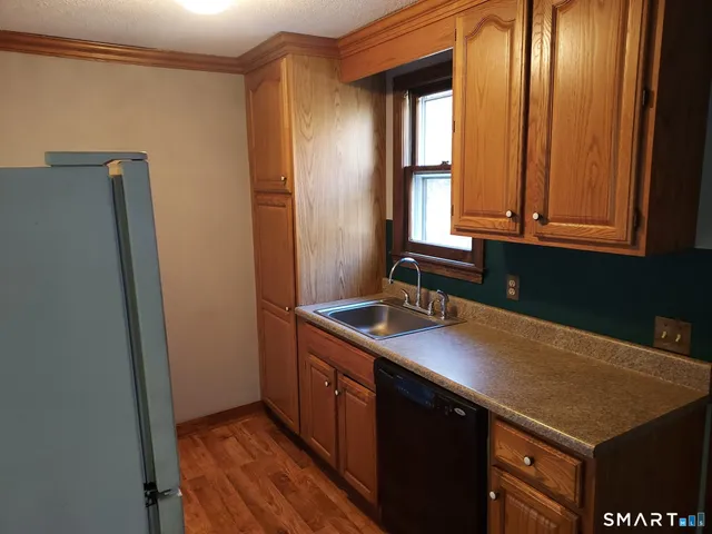 a kitchen with a sink a window and cabinets