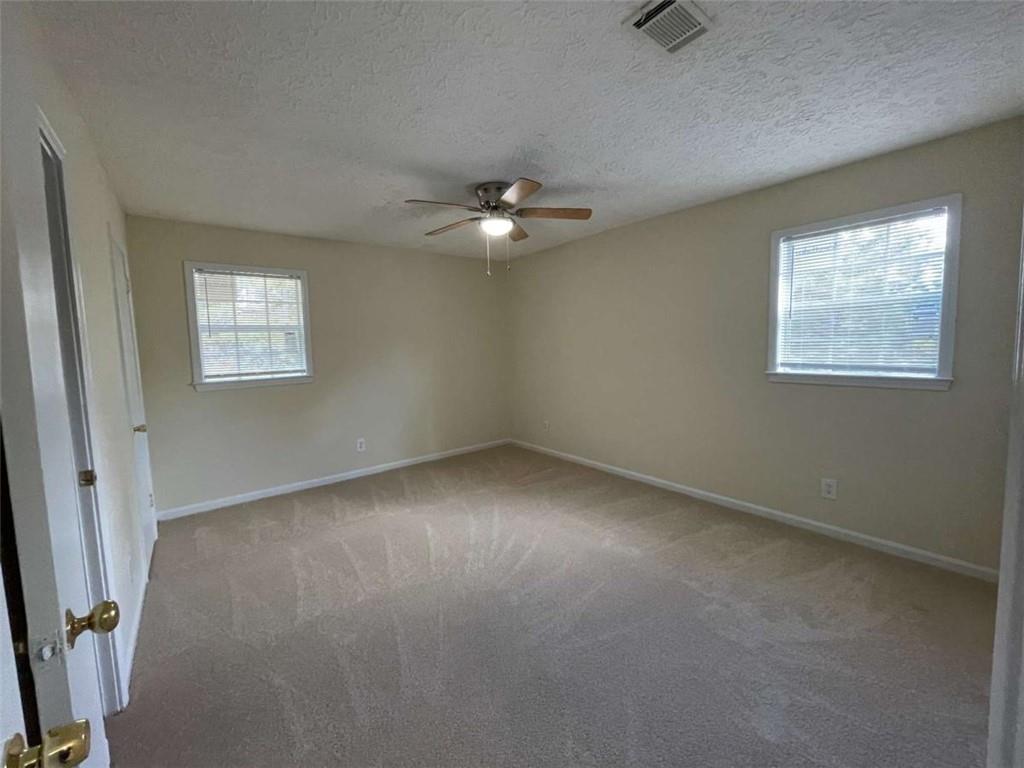 100 Plum Orchard Road, Unit B Covington, GA 30016 - Photo 11 of 15 an empty room with windows and fan