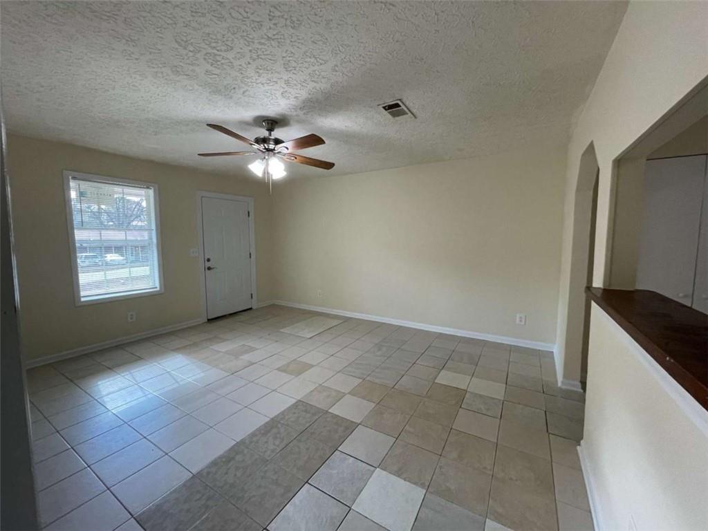 100 Plum Orchard Road, Unit B Covington, GA 30016 - Photo 4 of 15 an empty room with windows and ceiling fan