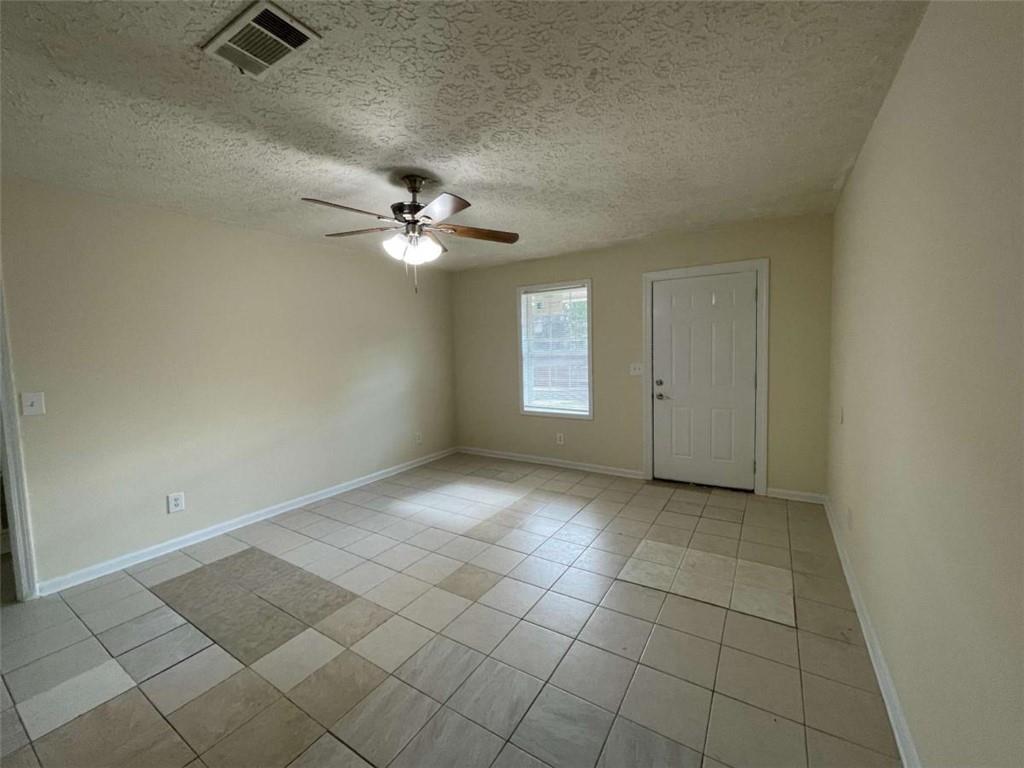 100 Plum Orchard Road, Unit B Covington, GA 30016 - Photo 5 of 15 an empty room with windows and fan