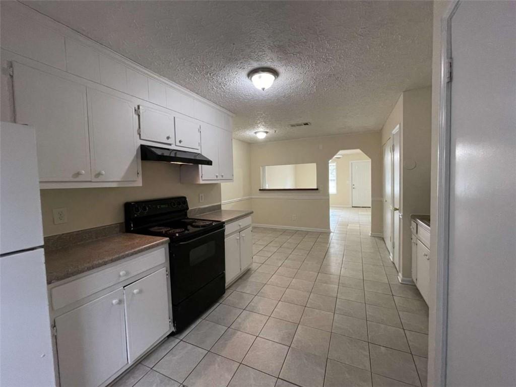 100 Plum Orchard Road, Unit B Covington, GA 30016 - Photo 8 of 15 a kitchen with stainless steel appliances granite countertop a sink and cabinets