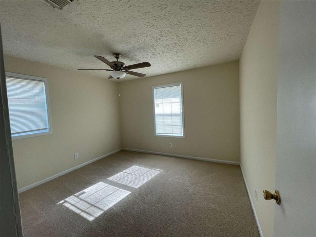 100 Plum Orchard Road, Unit B Covington, GA 30016 - Photo 9 of 15 an empty room with windows and fan