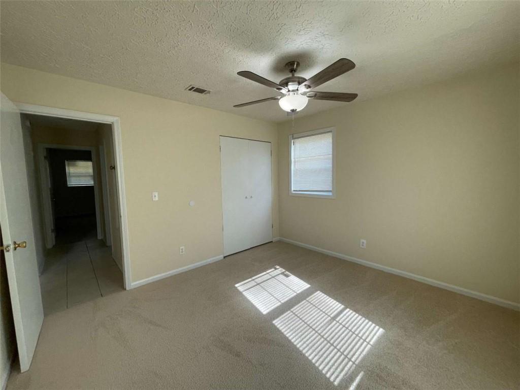 100 Plum Orchard Road, Unit B Covington, GA 30016 - Photo 10 of 15 an empty room with windows and ceiling fan