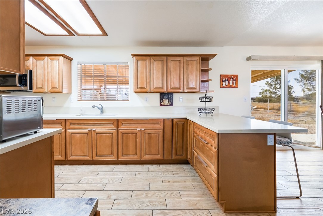 3631 South Blagg Road Pahrump, NV 89048 - Photo 16 of 47 Prepare meals in this kitchen, boasting ample counter space and sliding doors that open to scenic views.