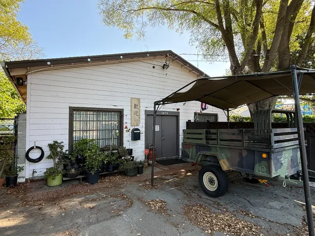 a view of an outdoor sitting area with golf table and chairs