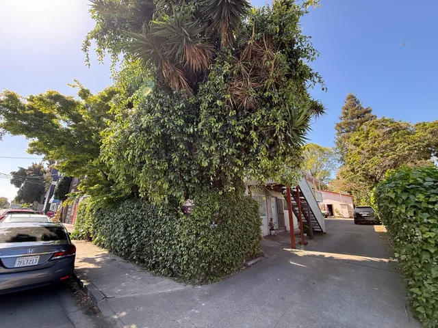 a view of a street with cars parked