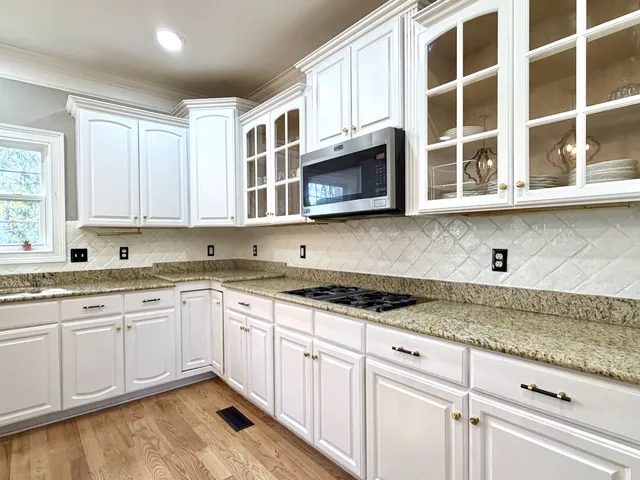 a kitchen with stainless steel appliances granite countertop a sink and cabinets