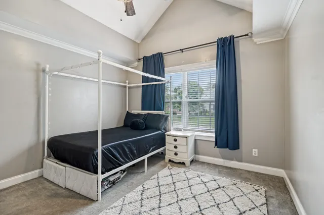 a bedroom with a bed and a window
