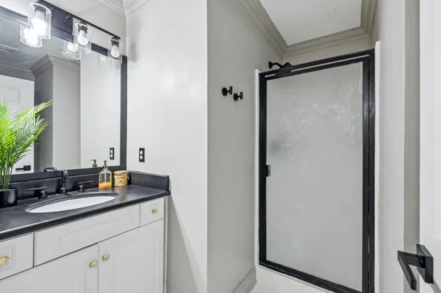 a bathroom with a double vanity sink and a mirror