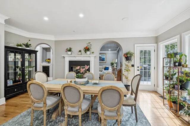 a dining room with furniture a rug and wooden floor
