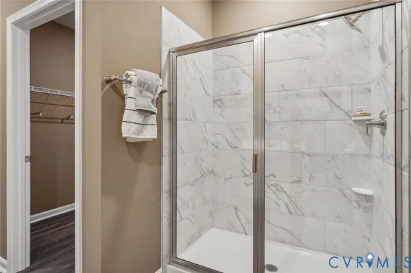 a bathroom with a glass shower door