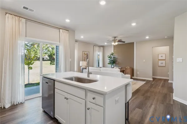 a large white kitchen with a large window