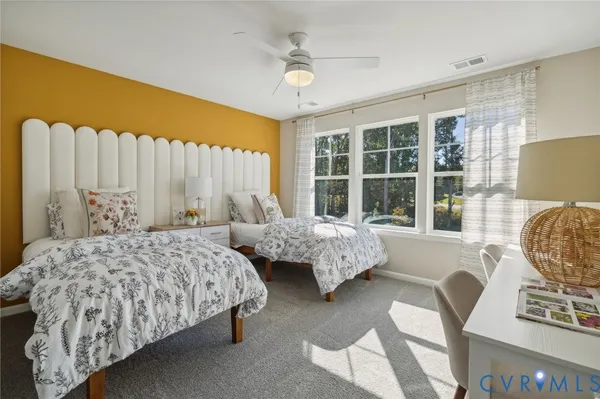 a bedroom with two beds and a large window