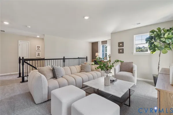 a living room with furniture potted plant and window