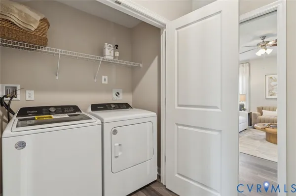 a view of washer and dryer with bathroom in the background
