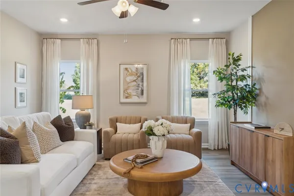 a living room with furniture and a potted plant
