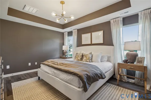 a bedroom with a bed and a chandelier
