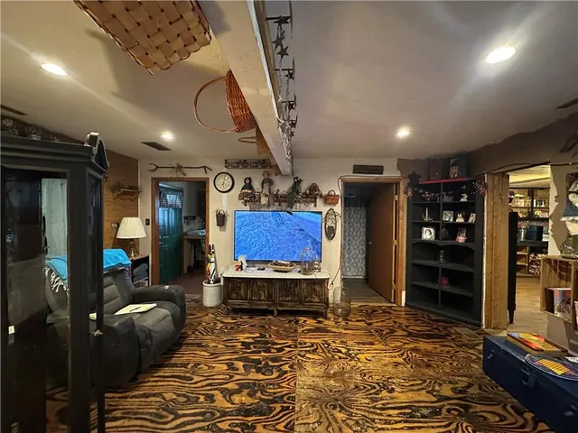 a living room with furniture a fireplace and gym equipment