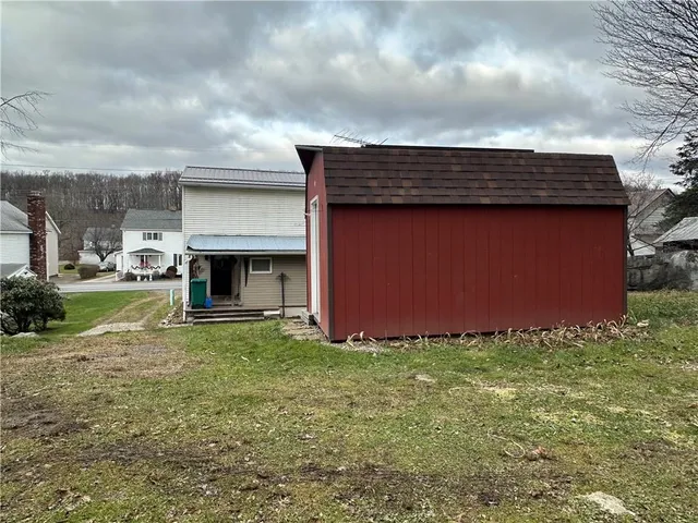 a view of swimming pool with lawn chairs and trees