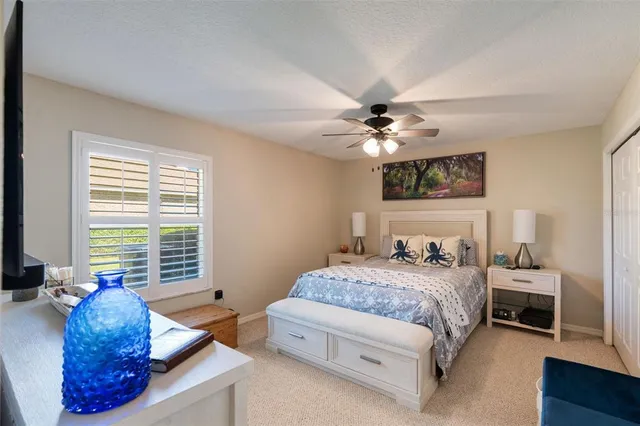 a bathroom with a granite countertop sink and a toilet