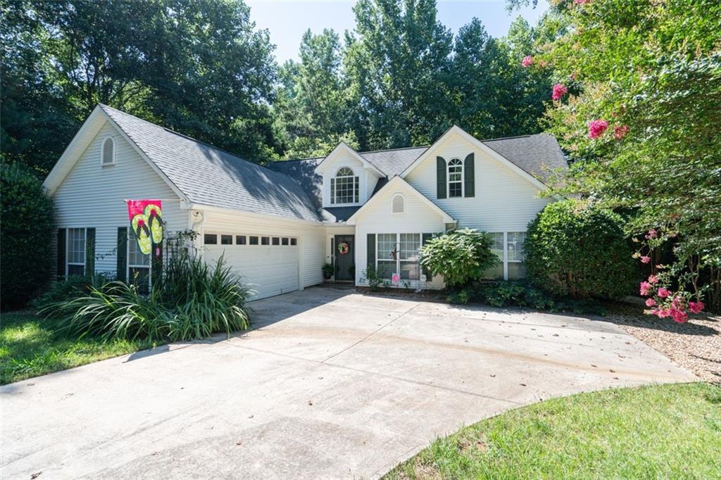 4221 Riviere Point Gainesville, GA 30507 - Photo 1 of 1 a front view of a house with a yard and garage