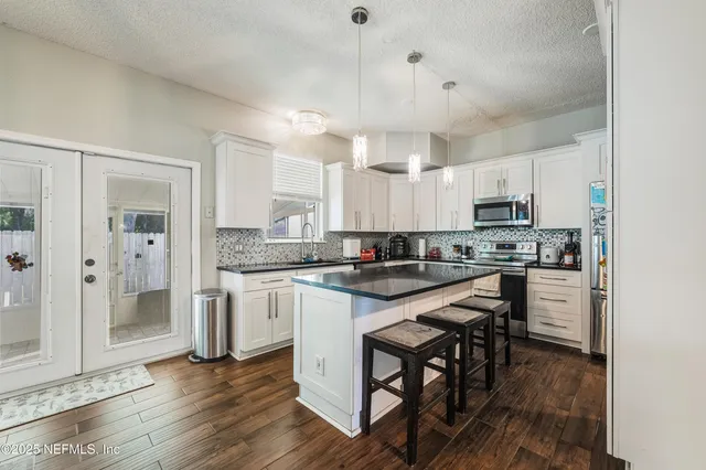 a bedroom with two beds and wooden floor