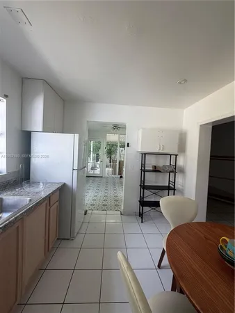 a kitchen with stainless steel appliances kitchen island granite countertop a refrigerator and a stove