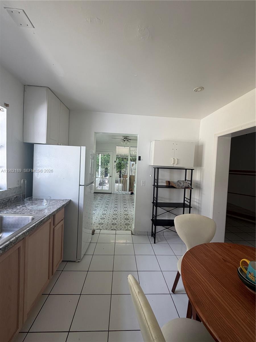 1025 Southwest 12th Street, Unit 2 Miami, FL 33129 - Photo 12 of 13 a kitchen with stainless steel appliances kitchen island granite countertop a refrigerator and a stove