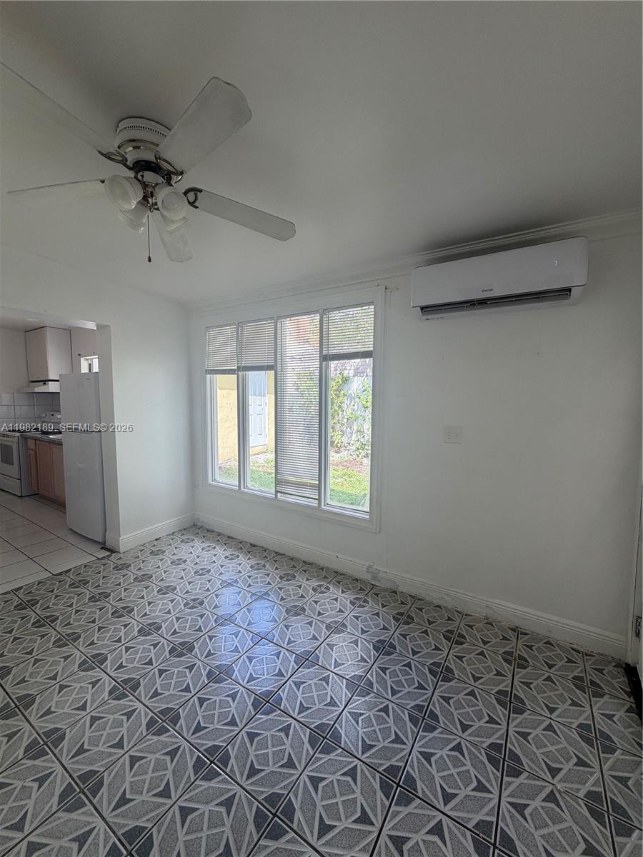 1025 Southwest 12th Street, Unit 2 Miami, FL 33129 - Photo 13 of 13 a view of a livingroom with a kitchen stove a sink and dishwasher