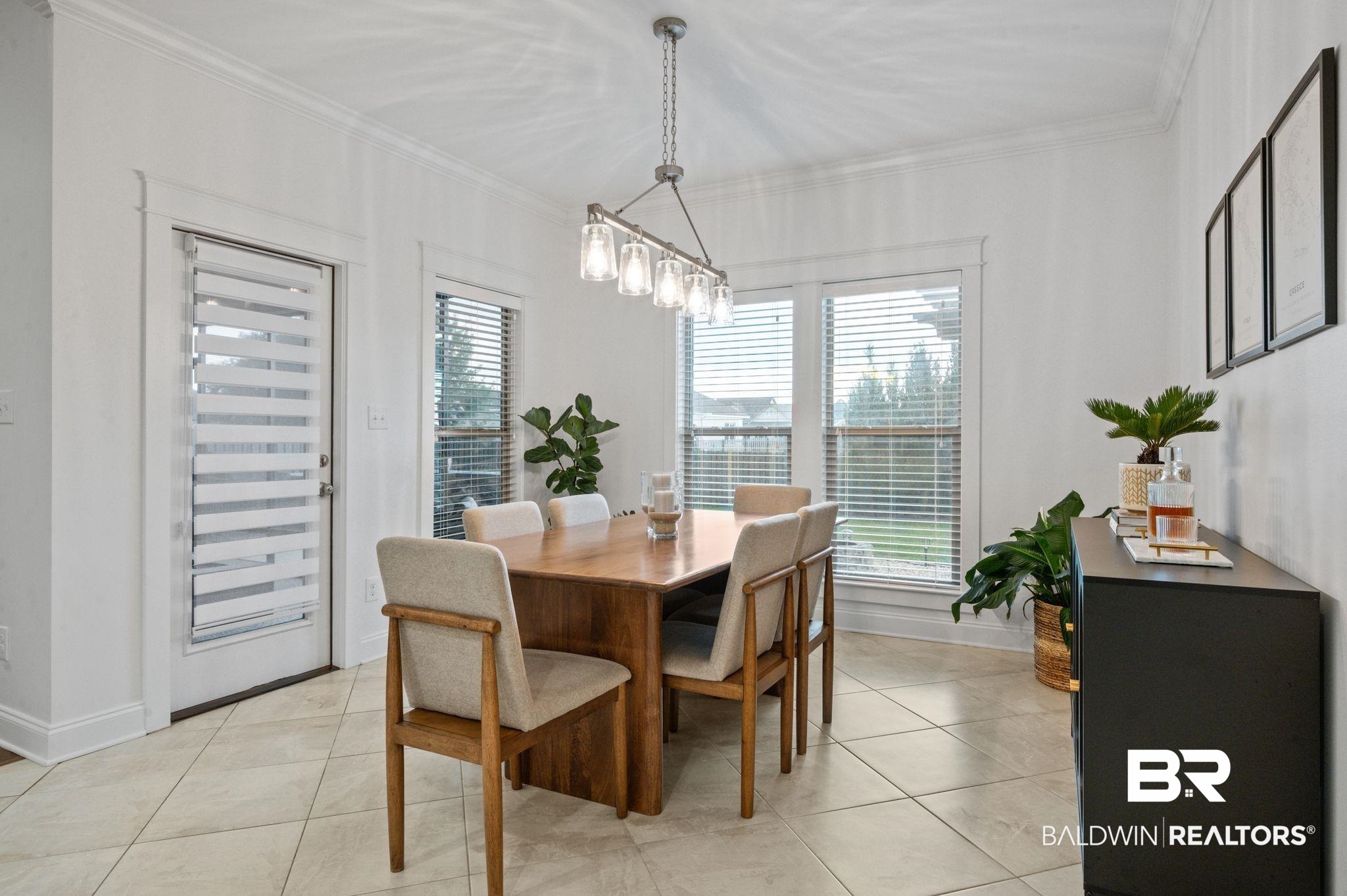 418 Fortune Drive Fairhope, AL 36532 - Photo 20 of 63 Tiled dining space with a notable chandelier and ornamental molding