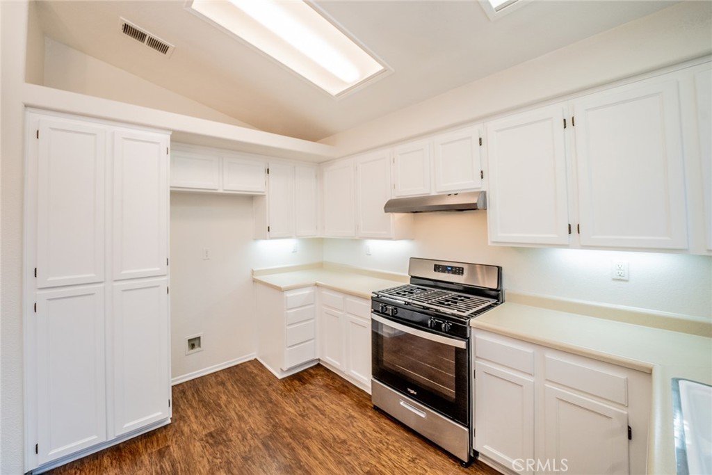 635 Laxford Road San Jacinto, CA 92583 - Photo 17 of 37 a kitchen with white cabinets and appliances