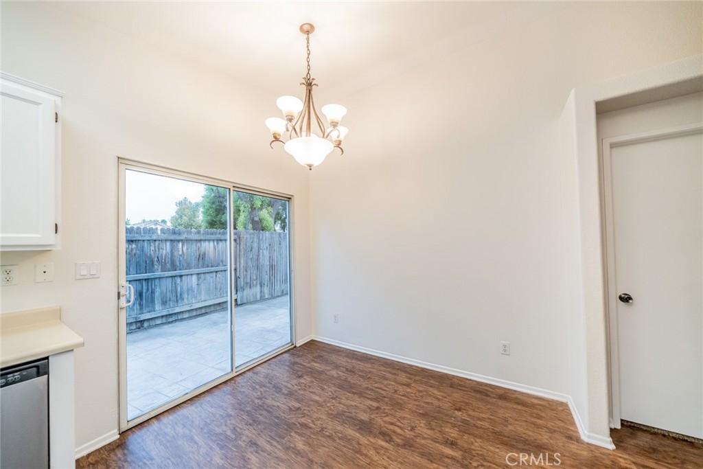 635 Laxford Road San Jacinto, CA 92583 - Photo 19 of 37 a view of a livingroom with wooden floor and a chandelier