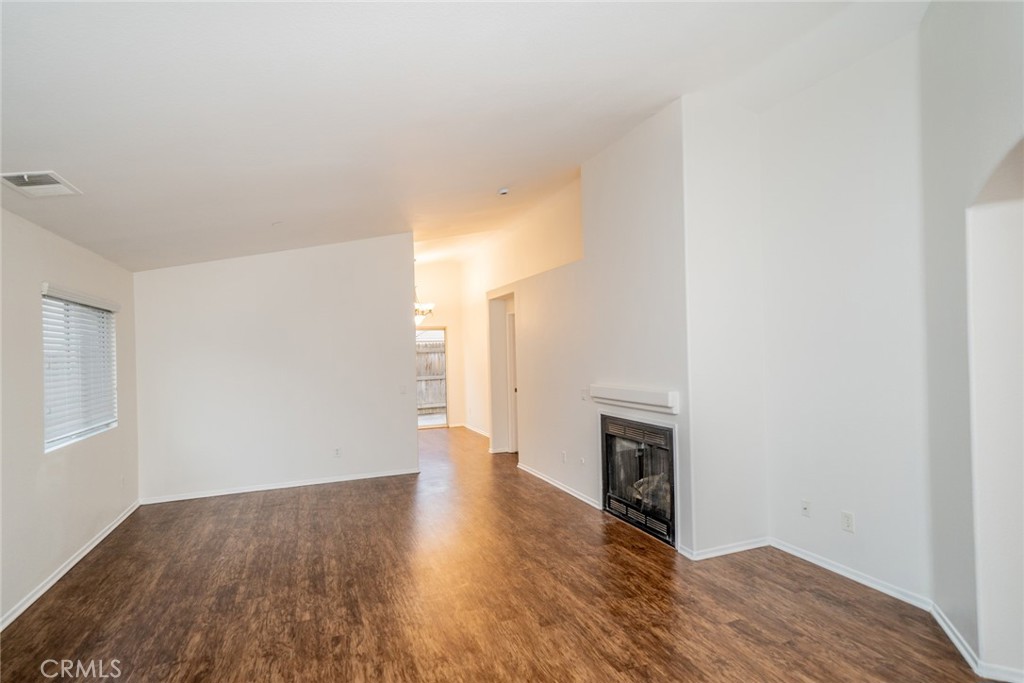 635 Laxford Road San Jacinto, CA 92583 - Photo 7 of 37 a view of a livingroom with wooden floor and a fireplace