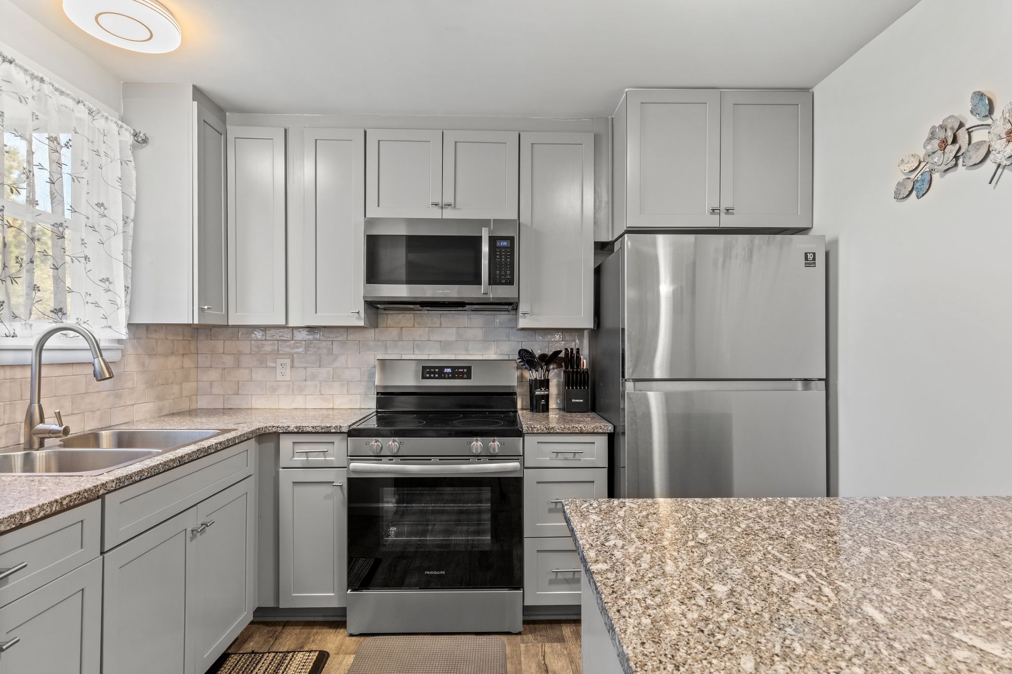 613 Hillsboro Road, Unit A11 Franklin, TN 37064 - Photo 4 of 26 a kitchen with stainless steel appliances a refrigerator stove and microwave