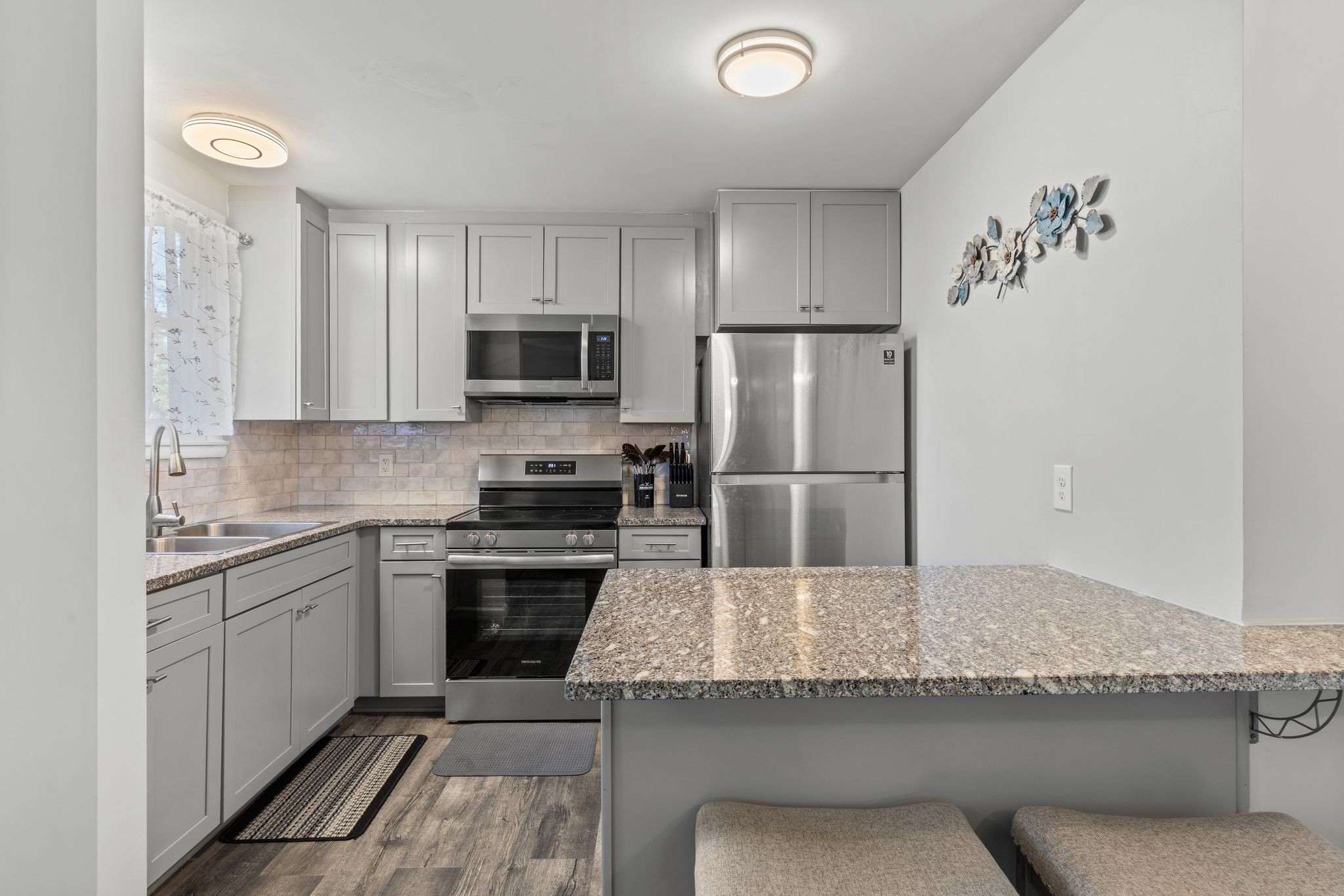 613 Hillsboro Road, Unit A11 Franklin, TN 37064 - Photo 10 of 26 a kitchen with a refrigerator sink and cabinets