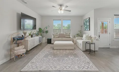 a living room with furniture and a large window