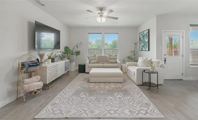 a living room with furniture and a large window