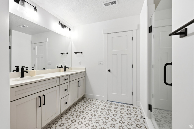 4646 Alder Drive, Unit 223 Mapleton, UT 84664 - Photo 12 of 35 Dual sink vanity featuring light gray cabinetry with matte black hardware, white countertops, and black wall-mounted faucets