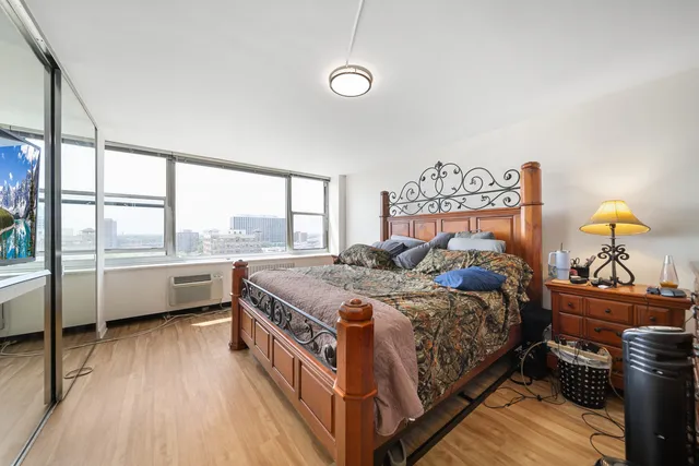 a bedroom with a bed and a large window