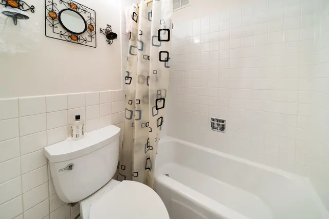 a bathroom with a toilet and a bathtub