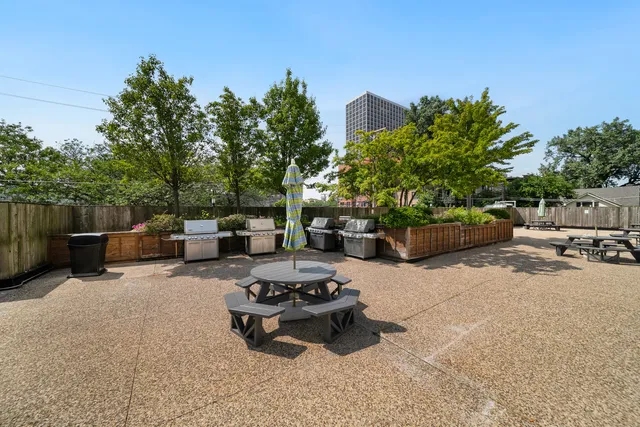 a view of a patio with couches and a fire pit and grass