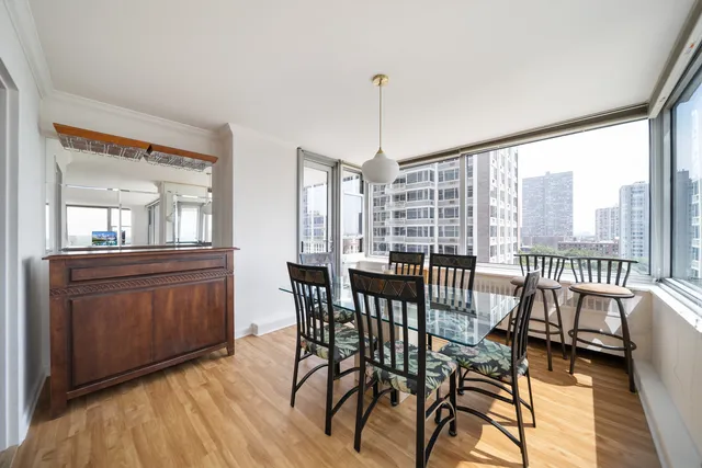 a view of a dining room with furniture window and wooden floor