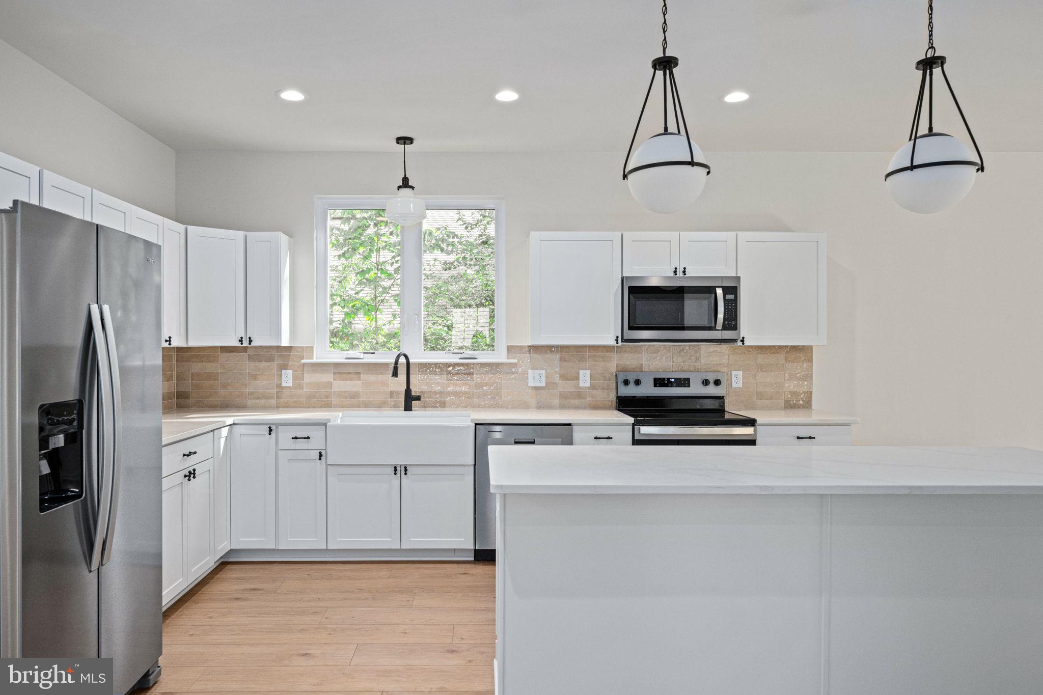 107 Saylers Creek Road Locust Grove, VA 22508 - Photo 19 of 78 a kitchen with stainless steel appliances a stove sink and microwave