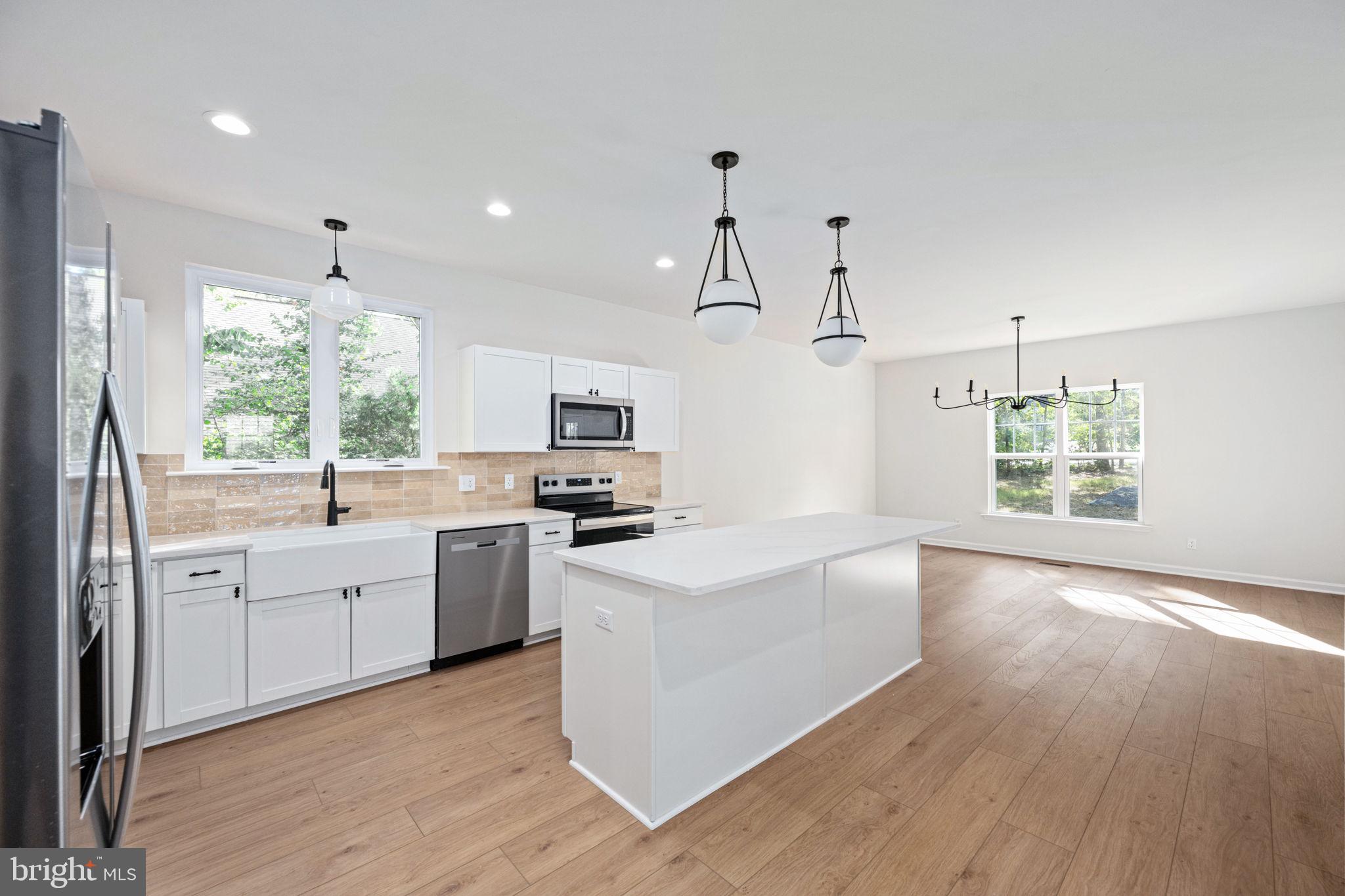 107 Saylers Creek Road Locust Grove, VA 22508 - Photo 20 of 78 a kitchen with white cabinets and white appliances