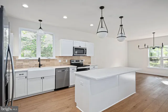 a view of a hallway with wooden floor and entryway