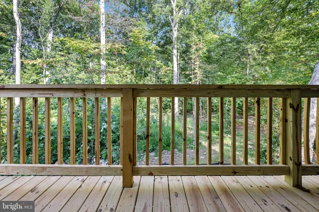 a bathroom with a granite countertop sink toilet and shower curtains